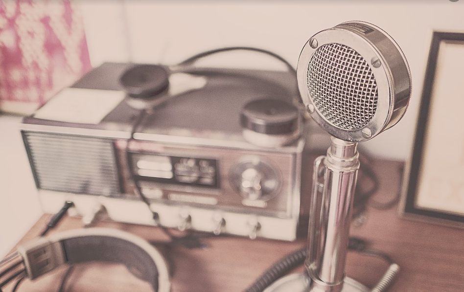 กิจการวิทยุกระจายเสียงในประเทศไทยมีมาตั้งแต่ พ.ศ.2470 ด้วยพระดำริของ พลเอกพระเจ้าบรมวงศ์เธอพระองค์เจ้าบุรฉัตรไชยากร กรมพระกำแพงเพชรอัครโยธิน เสนาบดีกระทรวงพาณิชย์และโทรคมนาคม พระองค์ทรงดำริตั้งสถานีวิทยุกระจายเสียงขึ้น เมื่อ พ.ศ.2471 โดยสั่งเครื่องส่งกระจายเสียงคลื่นสั้นเข้ามาทดลอง และให้อยู่ในความควบคุมของช่างวิทยุ กรมไปรษณีย์โทรเลข โดยใช้ชื่อสถานีว่า "4 พีเจ" ต่อมาได้มีการประกอบเครื่องส่งคลื่นขนาดกลาง 1 กิโลวัตต์ ขึ้น ทำการทดลองที่ตำบลศาลาแดงใช้ชื่อสถานีว่า "11 พีเจ" ซึ่งการใช้ชื่อสถานีว่า ‘พีเจ’ ในยุคนั้น ย่อมาจากคำว่า ‘บุรฉัตรไชยากร’ อันเป็นพระนามเดิมของพระองค์ท่าน หลังจากนั้นเมื่อวันที่ 25 กุมภาพันธ์ พ.ศ. 2473 ซึ่งตรงกับวันพระราชพิธีฉัตรมงคล ในรัชกาลพระบาทสมเด็จพระปกเกล้าเจ้าอยู่หัว พลเอก พระเจ้าบรมวงศ์เธอ กรมพระกำแพงเพชรอัครโยธิน ทรงเปิดการส่งวิทยุเป็นปฐมฤกษ์ โดยใช้ชื่อสถานีว่า "สถานีวิทยุกรุงเทพฯ ที่พญาไท" (Radio Bangkok at Phyathai) ตั้งอยู่ที่ วังพญาไท มีกำลังส่ง 2.5 กิโลวัตต์ โดยพิธีเปิดสถานีกระทำโดยอัญเชิญกระแสพระราชดำรัส ของพระบาทสมเด็จพระปกเกล้าเจ้าอยู่หัว เนื่องในวันพระราชพิธีฉัตรมงคล กระจายเสียงสู่พสกนิกร โดยมีใจความตอนหนึ่งว่า "การวิทยุกระจายเสียงที่ได้ริเริ่มจัดตั้งขึ้น และทำการทดลองตลอดมานั้น ก็ด้วยความมุ่งหมายที่จะส่งเสริมการศึกษา การค้าขาย และการบันเทิงแก่พ่อค้าประชาชน" นับเป็นครั้งแรกที่มีการถ่ายทอดเสียงทางวิทยุในประเทศไทย